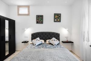 a bedroom with a bed with two pillows on it at Silvana's House in Agerola
