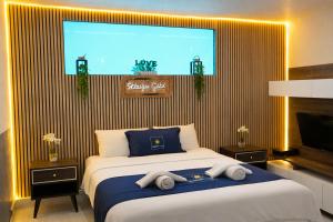 a bedroom with a large bed with towels on it at Exclusive Villas in Kuşadası