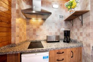 a kitchen with a stove and a counter top at los diablitos 4 in San Juan de la Rambla +14 photos