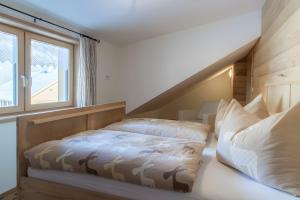 a bedroom with a bed and a window at Appartement Moosmann in Mellau