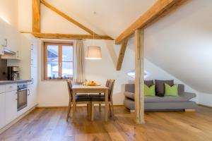 a kitchen and dining room with a table and a couch at Appartement Moosmann in Mellau +33 photos