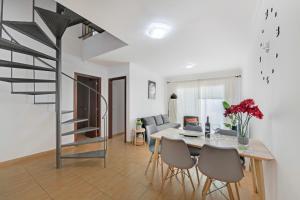 a dining room and living room with a table and chairs at Atico Olia in Los Llanos de Aridane +19 photos