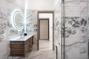 a bathroom with a sink and a mirror at Silvana's House in Agerola +54 photos