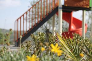 a staircase in a playground with flowers in the foreground at Exclusive Villas in Kuşadası +41 photos
