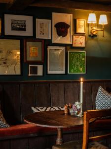 a room with a table and a wall with pictures at The Queen's Head in Broad Chalke +56 photos