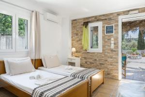 two beds in a room with a balcony at Ilias Studios Sevasti Kalymnos in Panormos Kalymnos +48 photos