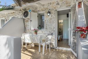 a dining room with a table and chairs at Ilias Studios Sevasti Kalymnos in Panormos Kalymnos