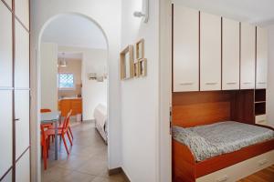 a small bedroom with a bed and a table at Villa di Diana in Diano Castello +48 photos