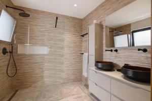 a bathroom with a sink and a shower at Villa Alvor Rooftop in Alvor +14 photos