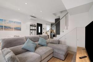 a living room with a couch and a staircase at Villa Alvor Rooftop in Alvor