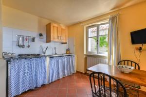 a kitchen with a table and a counter top at Mare e natura in Marciana