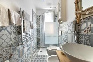 a bathroom with a tub and a toilet at Mare e natura in Marciana +13 photos