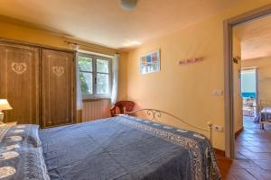 a bedroom with a bed in a room with a window at Mare e natura in Marciana