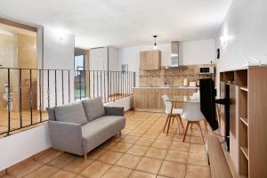 a living room with a couch and a kitchen at Montemar 2 in Moya