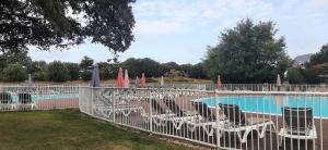 a group of chairs and umbrellas next to a pool at Maison Village Port-Bourgenay in Saint-Hilaire-de-Talmont