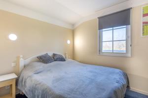 a bedroom with a large bed and a window at Maison Village Port-Bourgenay in Saint-Hilaire-de-Talmont +16 photos