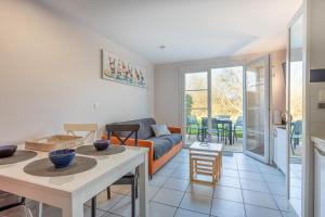 a living room with a couch and a table at Maison Village Port-Bourgenay in Saint-Hilaire-de-Talmont