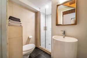 a bathroom with a toilet and a sink and a mirror at Gîte Le Jorat - Appartement C in Bogève +28 photos
