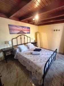 a bedroom with a large bed in a room at Casa Orymar in El Cotillo