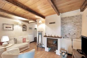 a living room with a couch and a fireplace at Casa Vittorina in Cesio