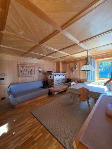 a living room with a bed and a couch at Piciulei Grant in Selva di Val Gardena
