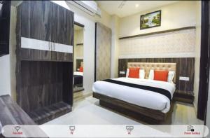 a bedroom with a large bed and a fireplace at Hotel West Guest House in Gangtok