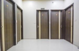 a row of wooden doors in a room with at Hotel West Guest House in Gangtok
