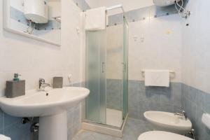 a bathroom with a sink and a toilet and a shower at Kalès home in Otranto in Otranto +20 photos