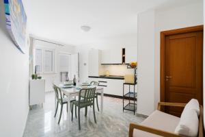 a kitchen and dining room with a table and chairs at Kalès home in Otranto in Otranto