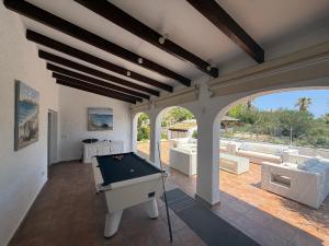 a room with a pool table on a patio at Caroix in Jávea