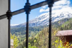 a view of a snowy mountain from a window at Maison Jaccod_piano terra in Morgex
