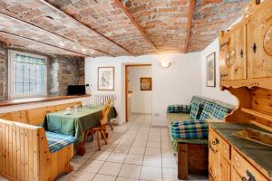 a kitchen and dining room with a table and chairs at Maison Jaccod_piano terra in Morgex