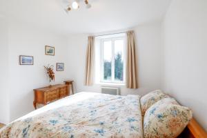a bedroom with a bed and a window at Chambres d'hôtes pleine nature in Plougonven