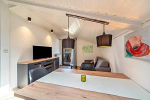 a room with a table and a tv and a couch at Residence Kronstein - Fewo 9 in Tesimo