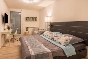 a bedroom with a large bed and a desk at Ferienwohnung Im Haidelmoos in Konstanz