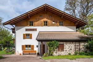 a house with a bench in front of it at Stablerhof Apt Löwenzahn in Cornedo all'Isarco
