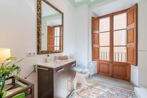 a bathroom with a sink and a mirror and a toilet at S'alqueria in Sóller +18 photos