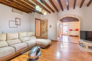 a living room with a couch and a tv at Ca Sa Cristeta de Sescola in Sa Pobla