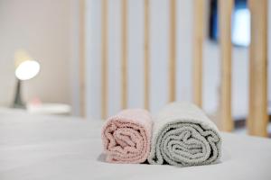 a pair of towels sitting on top of a bed at Babosas Charm in Funchal +8 photos