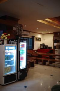 a cocacola soda machine sitting in a room at Emporium Chiangmai in Chiang Mai