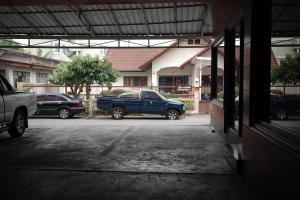a parking lot with cars parked in front of a building at Emporium Chiangmai in Chiang Mai