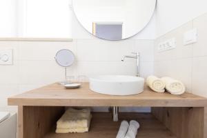 a bathroom with a sink and a mirror at Kleon 1 in Rifiano +25 photos