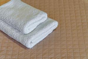 two towels sitting on top of a tile floor at Saint Peter Bay - Basic Room in Kavos +30 photos