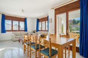 a dining room with a wooden table and chairs at Coma-ruga in El Vendrell