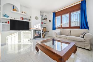 a living room with a couch and a coffee table at Coma-ruga in El Vendrell