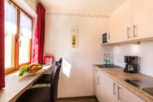 a kitchen with a table with a bowl of fruit on it at Gästehaus Wolfgang Taubensee in Ruhpolding