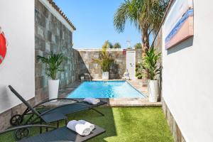 a swimming pool in the backyard of a house at Casa Bombón in Vejer de la Frontera