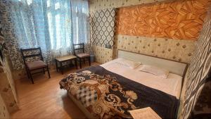 a bedroom with a bed with a wooden headboard and chairs at R Krishna Hotel in Srinagar