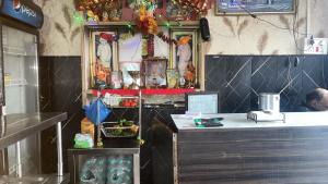 a restaurant with a counter and a counter sidx sidx sidx at R Krishna Hotel in Srinagar