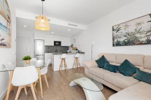 a living room with a couch and a table at Adhara 053 in Torre del Mar